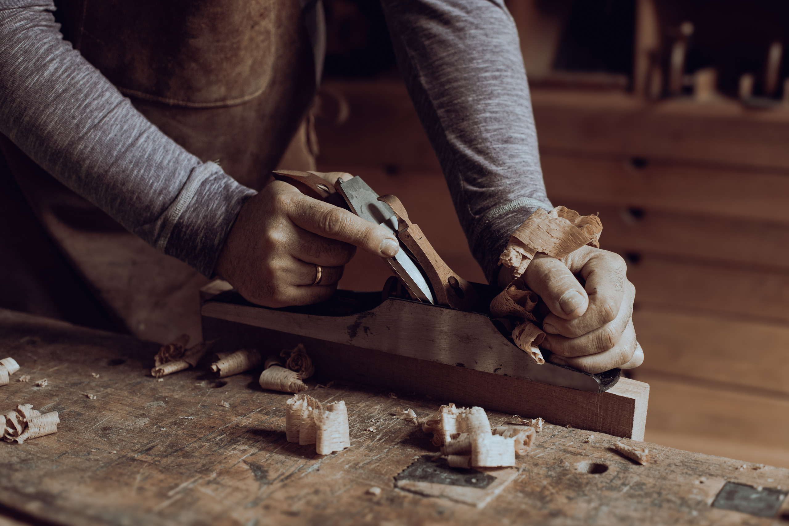 stolarz pracuje strugiem ręcznym
