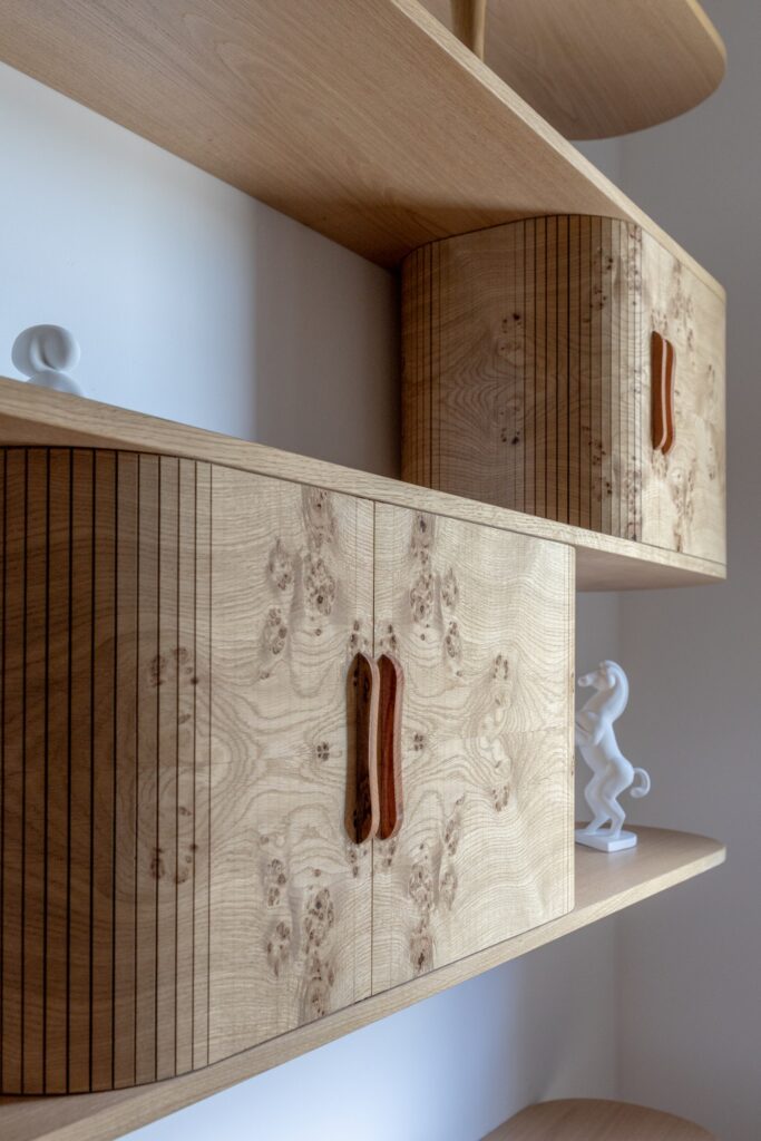 The Jazz bookcase with tambours made from knotty oak